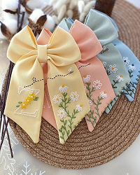 Pastel colored hair bows with floral patterns